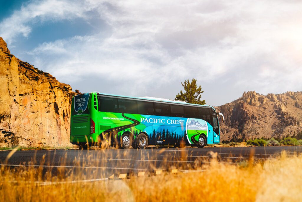 PCBL Charter Bus in front of beautiful rocky hills