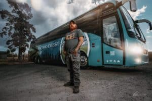 Hero picture of man who applied the new vinyl wrap to the Pacific Crest Bus Lines Buses
