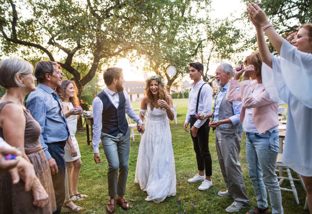 Couple getting marries outside with family members around