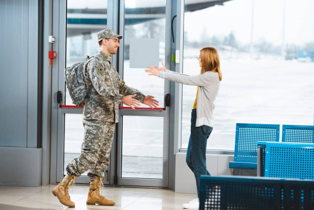 Military soldier in uniform greeting his wife at an airport