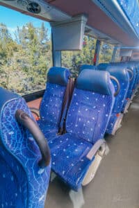 Interior of large Pacific Crest Charter Bus seats and window view